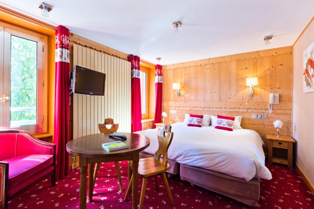 Un ou plusieurs lits dans un hébergement de l'établissement Aiguille du Midi - Hôtel & Restaurant