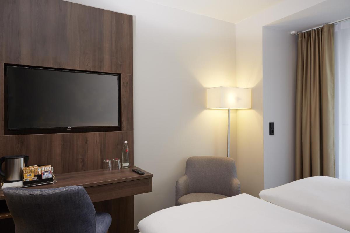 Ein Bett oder Betten in einem Zimmer der Unterkunft HYPERION Hotel Berlin