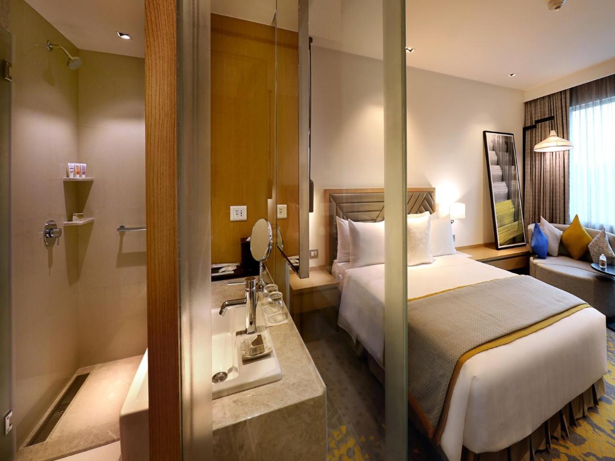 a hotel room with a bed and a sink at Welcomhotel by ITC Hotels, RaceCourse, Coimbatore in Coimbatore