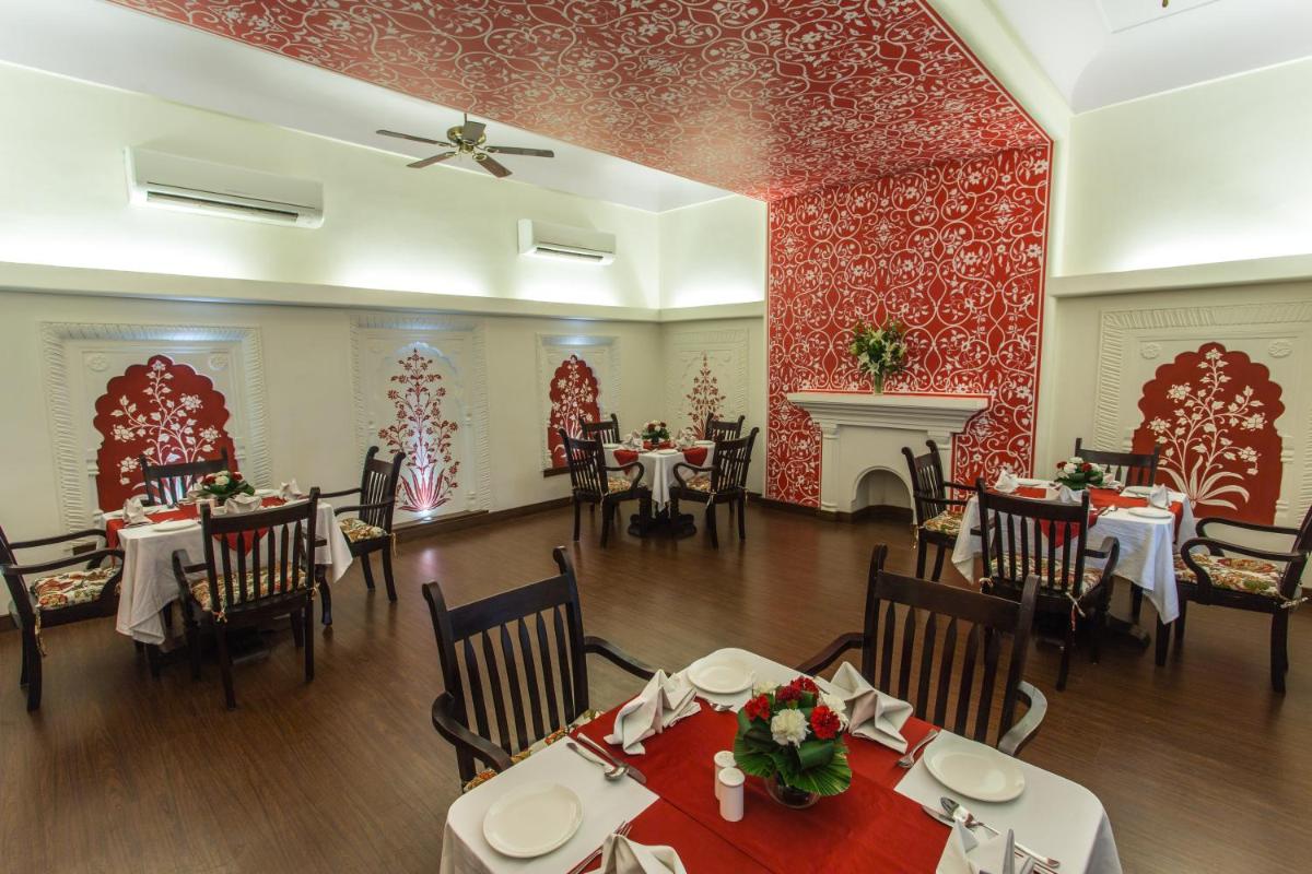 a restaurant with tables and chairs in a room at Royal Heritage Haveli - By Leisure Hotels in Jaipur