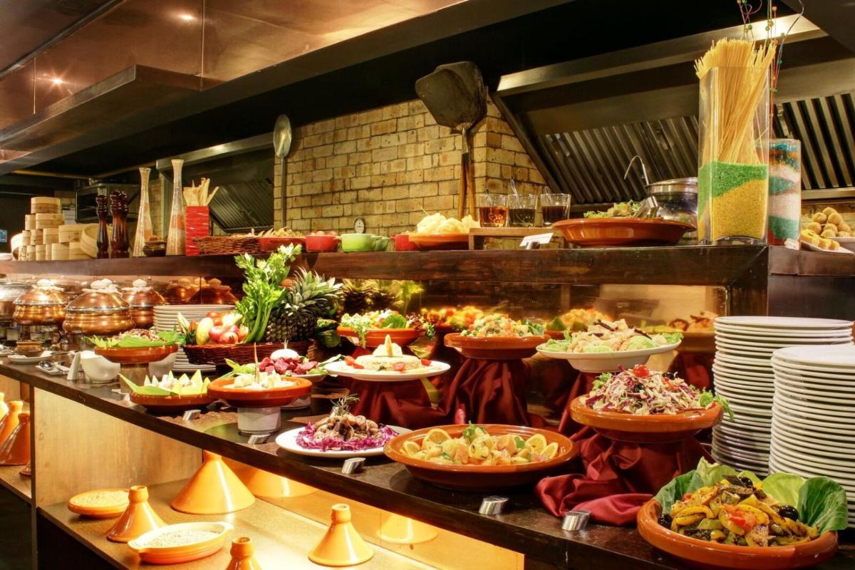 a buffet line with many plates and bowls of food at Svenska Design Hotel in Mumbai