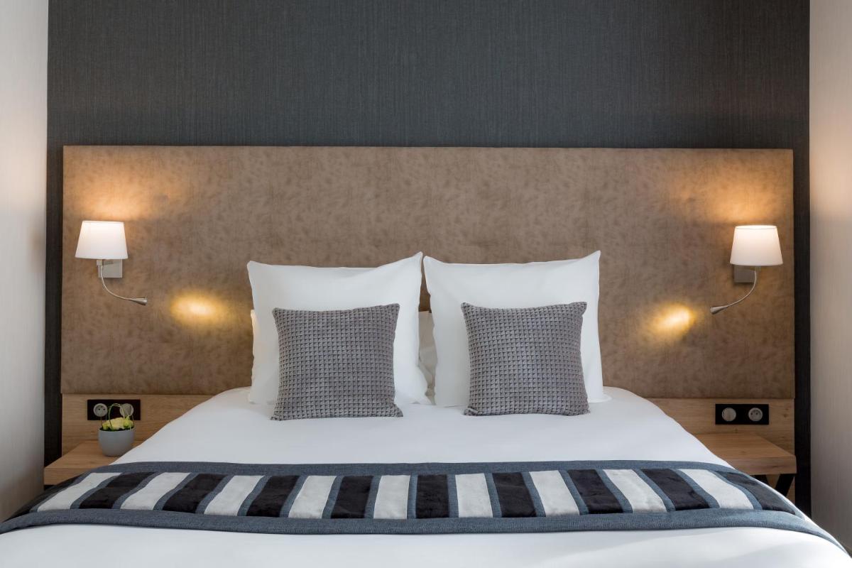 Un ou plusieurs lits dans un hébergement de l'établissement Hôtel Le Rive Droite & SPA