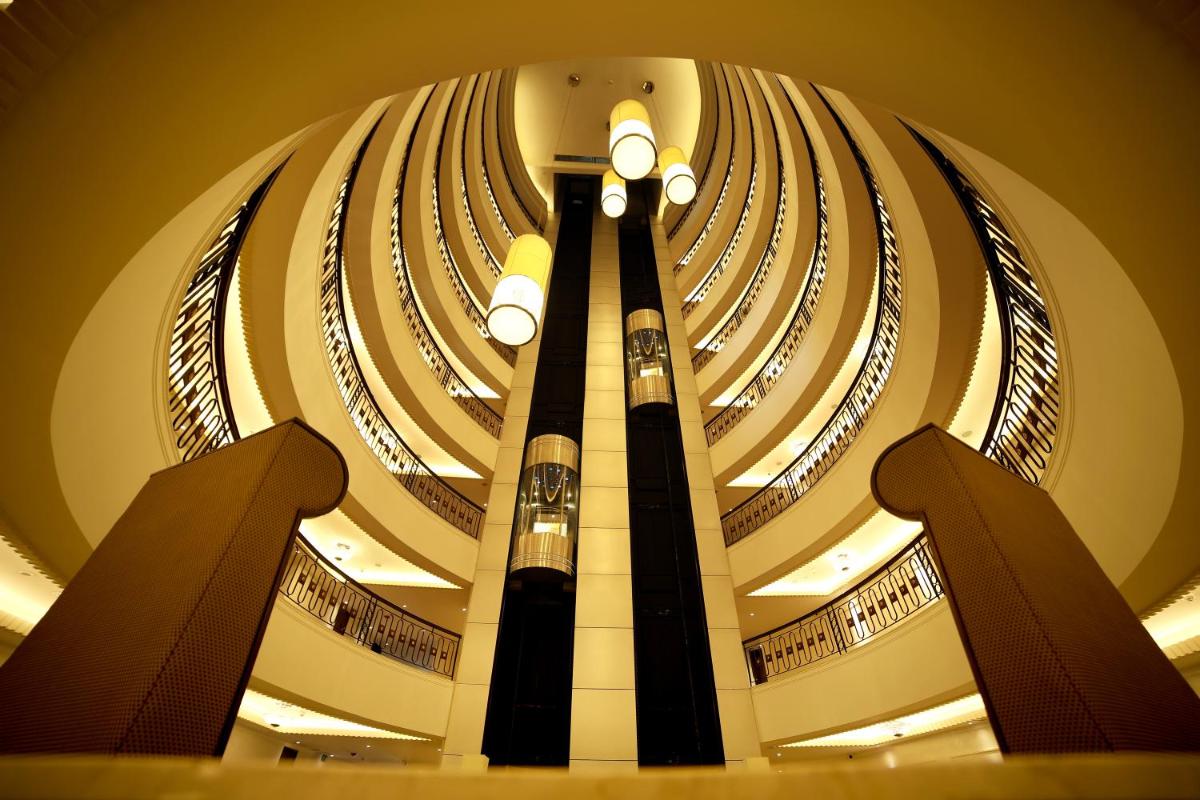 a large building with a ceiling with many windows at Ramada Plaza Chennai in Chennai