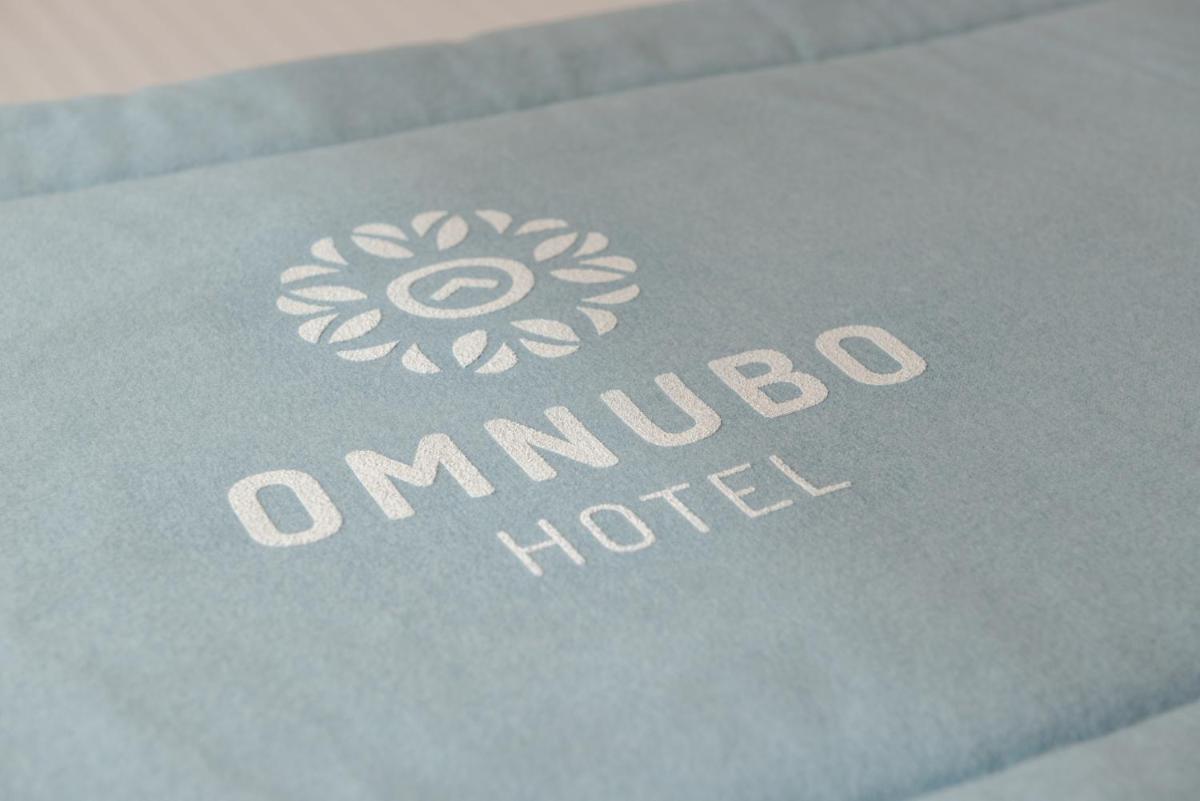 Un ou plusieurs lits dans un hébergement de l'établissement Hôtel Omnubo Collection