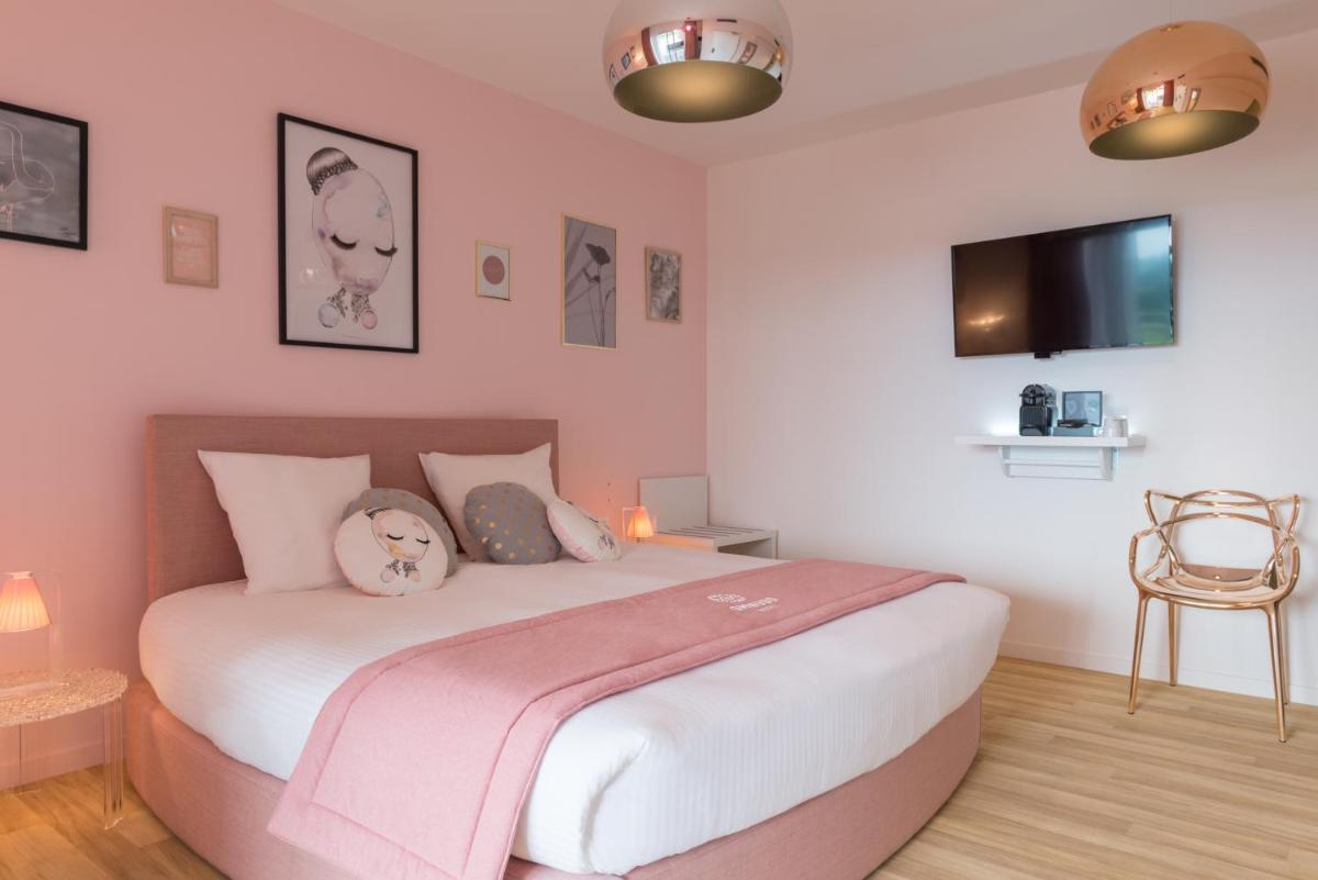 Un ou plusieurs lits dans un hébergement de l'établissement Hôtel Omnubo Collection