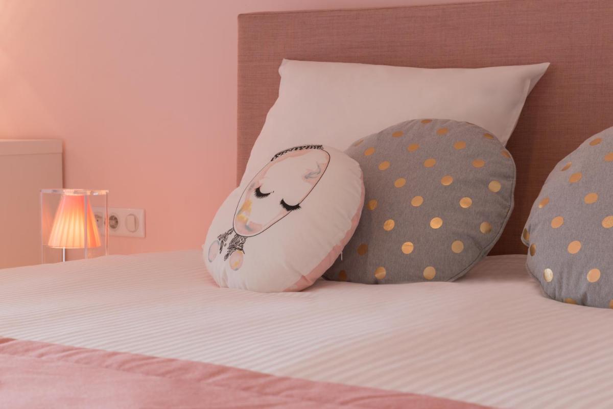 Un ou plusieurs lits dans un hébergement de l'établissement Hôtel Omnubo Collection