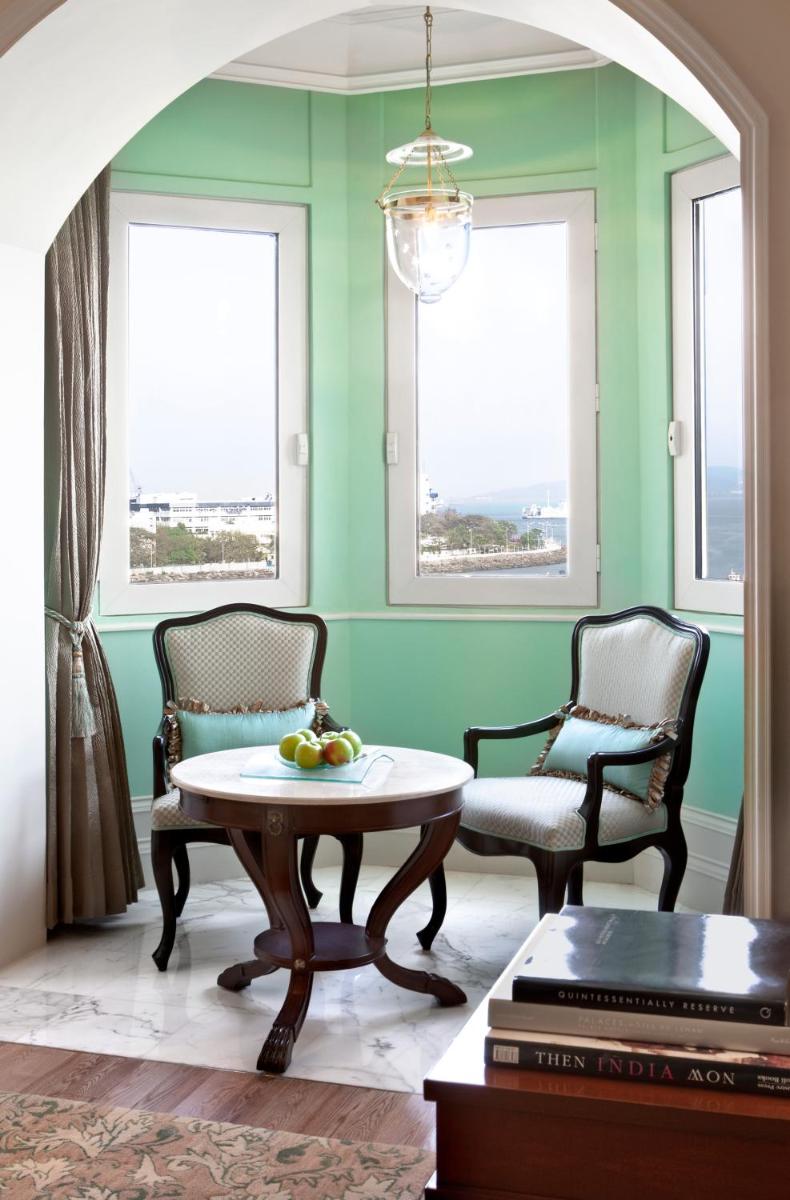 a living room with a table and two chairs at The Taj Mahal Palace, Mumbai in Mumbai a living room with a table and two chairs at The Taj Mahal Palace, Mumbai in Mumbai