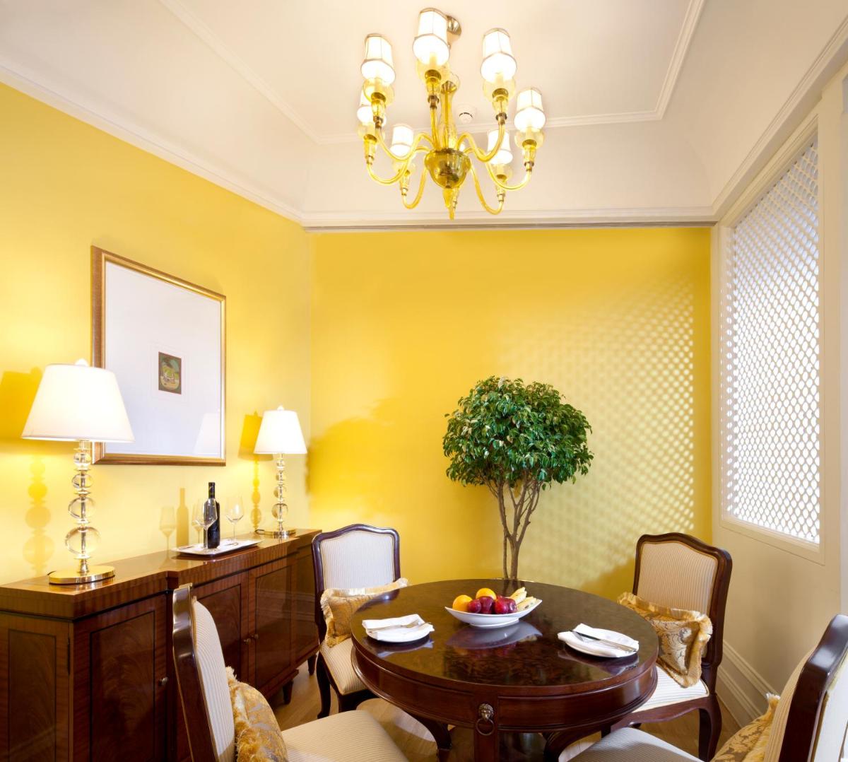 a dining room with a table and chairs at The Taj Mahal Palace, Mumbai in Mumbai a dining room with a table and chairs at The Taj Mahal Palace, Mumbai in Mumbai