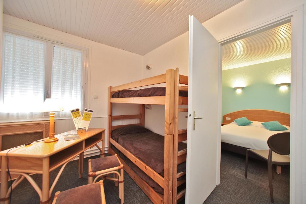 Un ou plusieurs lits dans un hébergement de l'établissement Hotel Les Dunes