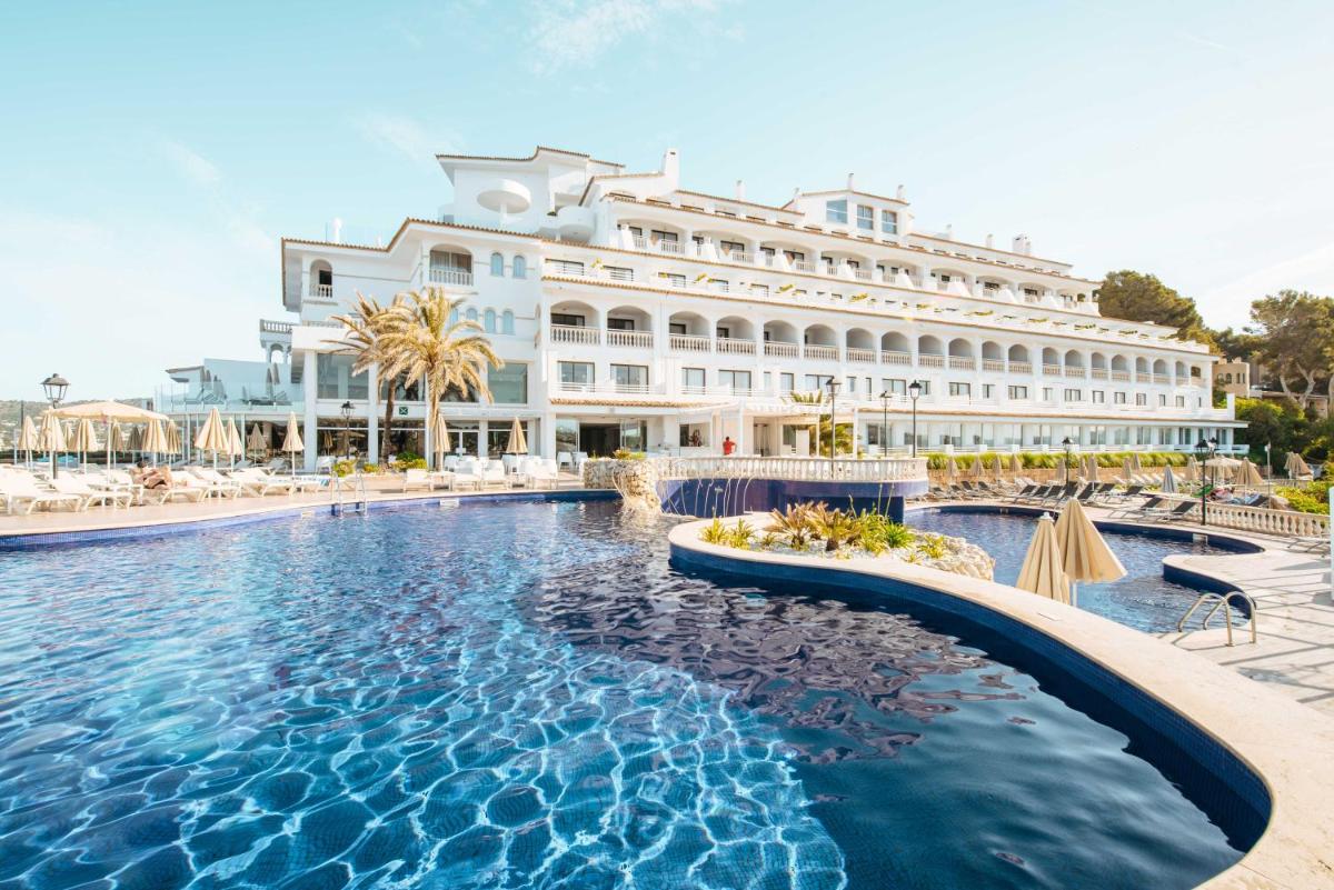 un hotel con piscina frente a un edificio en Sentido Fido Punta del Mar Hotel & Spa - Adults Only, en Santa Ponsa