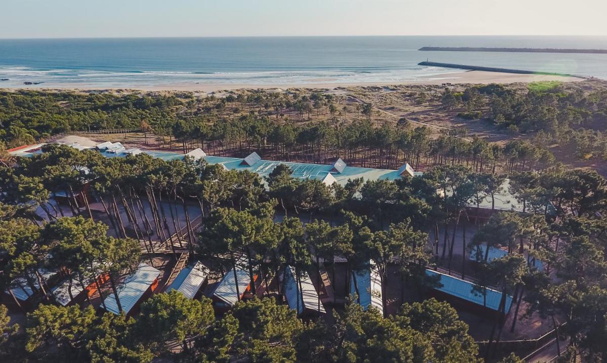 uma vista aérea de um resort com árvores e o oceano em FeelViana Sport Hotel em Viana do Castelo