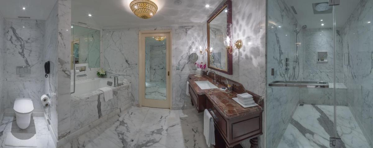 a bathroom with a tub and a sink and a shower at The Taj Mahal Palace, Mumbai in Mumbai a bathroom with a tub and a sink and a shower at The Taj Mahal Palace, Mumbai in Mumbai