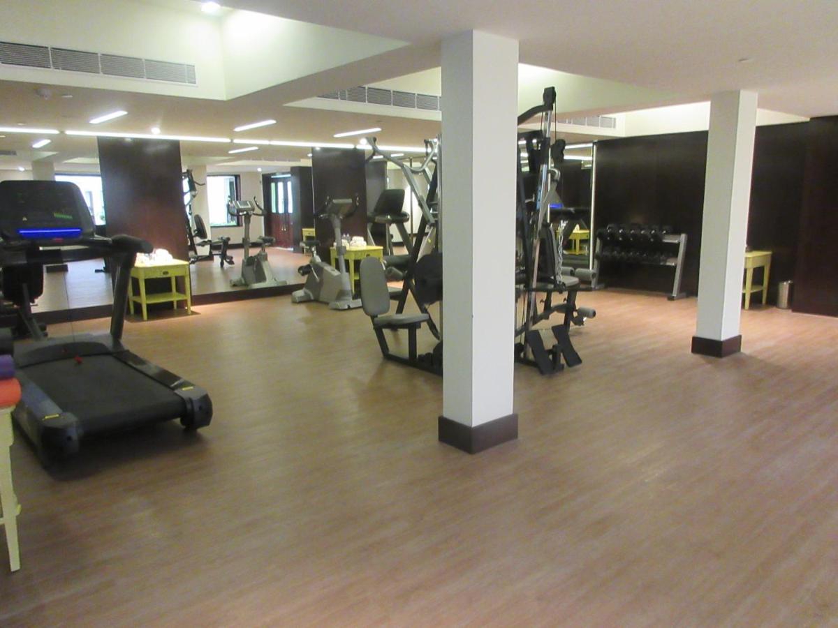 a gym with several treadmills and exercise equipment at Fragrant Nature Kochi - A Five star Classified Hotel in Cochin