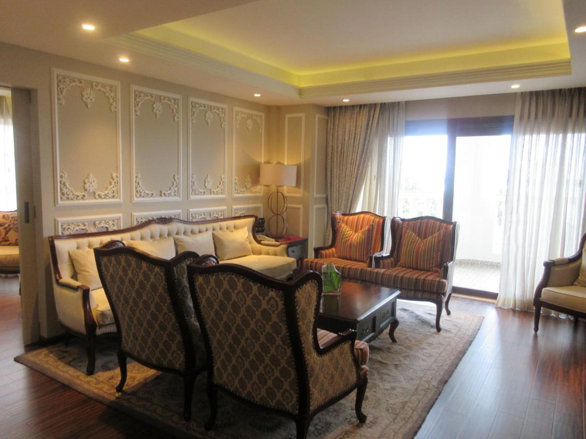 a living room with chairs and a couch and a table at Fragrant Nature Kochi - A Five star Classified Hotel in Cochin