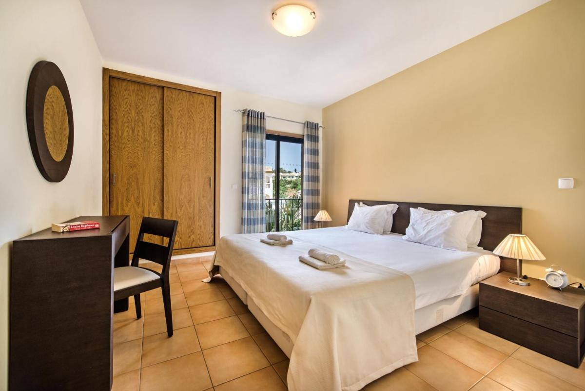 Uma cama ou camas num quarto em Estrela da Luz Resort