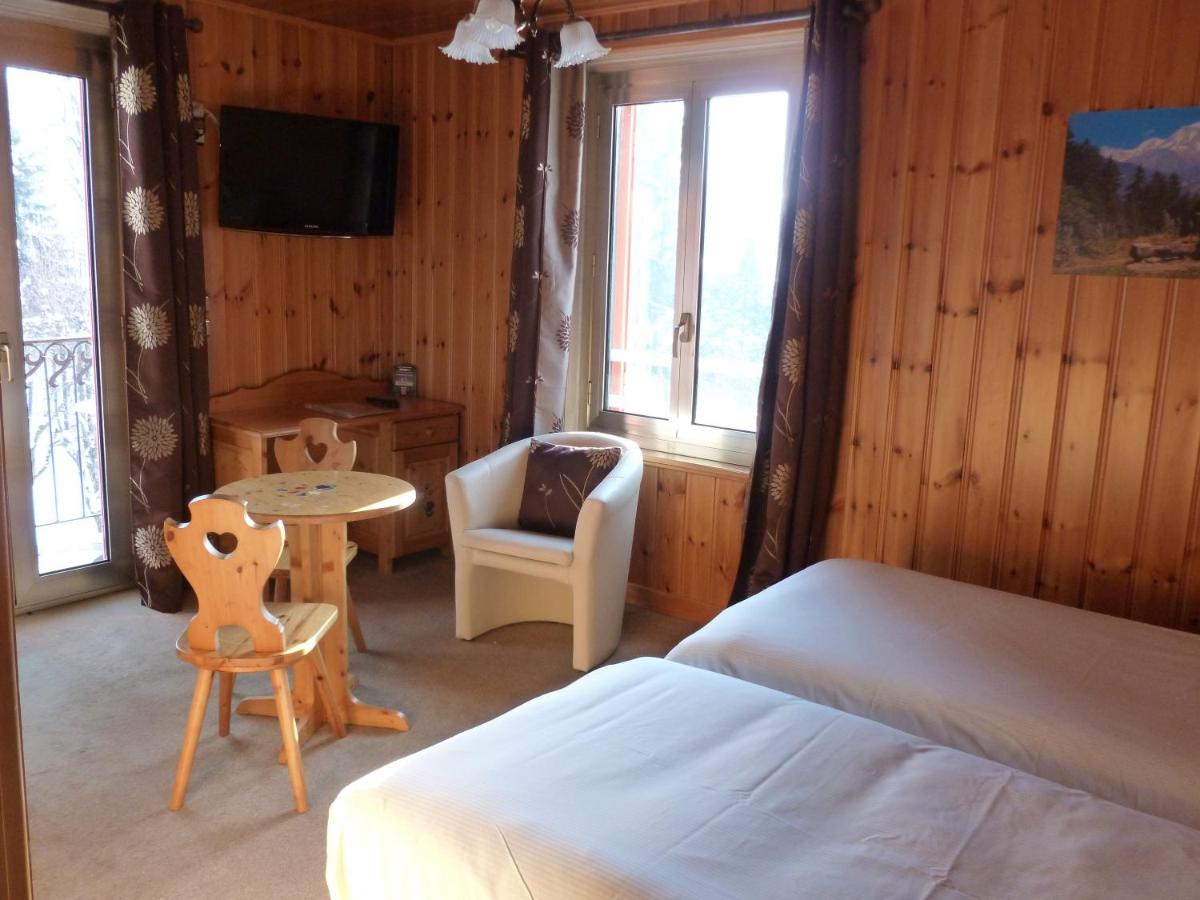 Un ou plusieurs lits dans un hébergement de l'établissement Aiguille du Midi - Hôtel & Restaurant