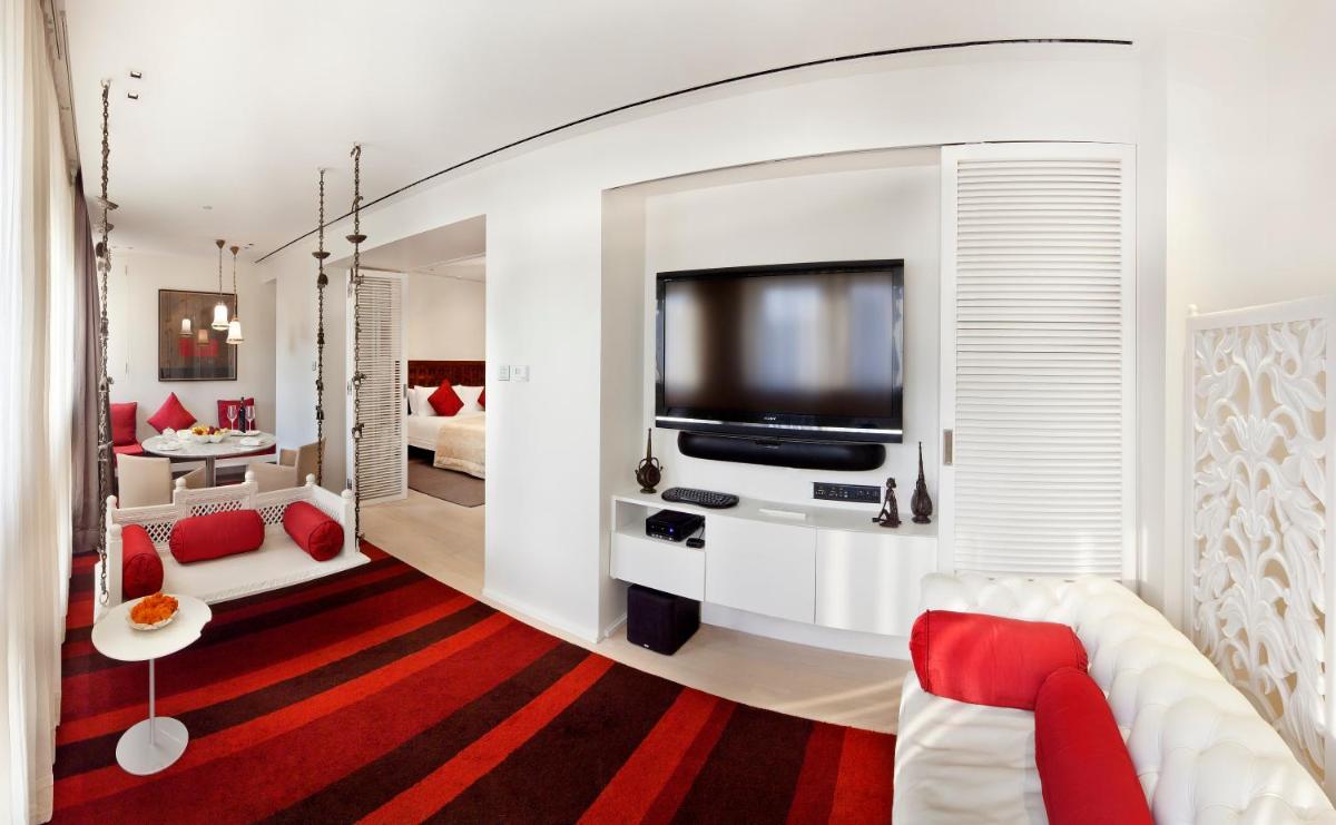 a living room with a couch and a tv at The Taj Mahal Palace, Mumbai in Mumbai a living room with a couch and a tv at The Taj Mahal Palace, Mumbai in Mumbai