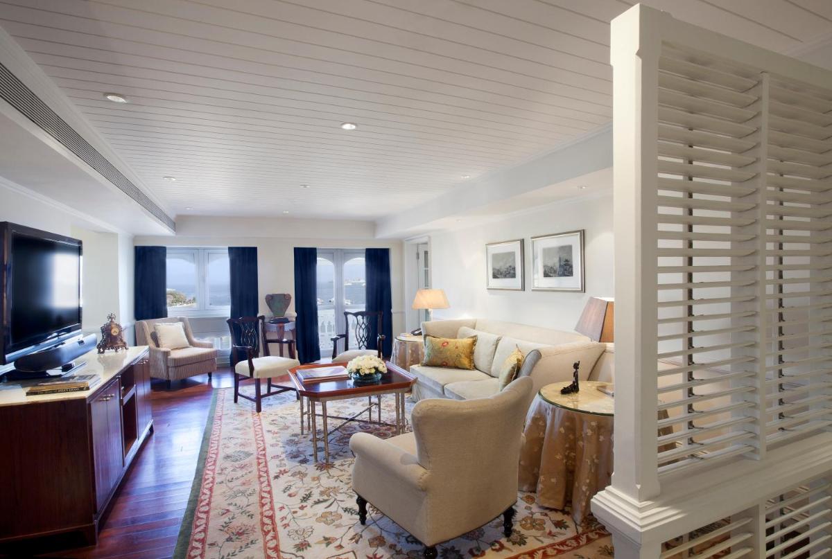 a living room with a couch and a tv at The Taj Mahal Palace, Mumbai in Mumbai a living room with a couch and a tv at The Taj Mahal Palace, Mumbai in Mumbai