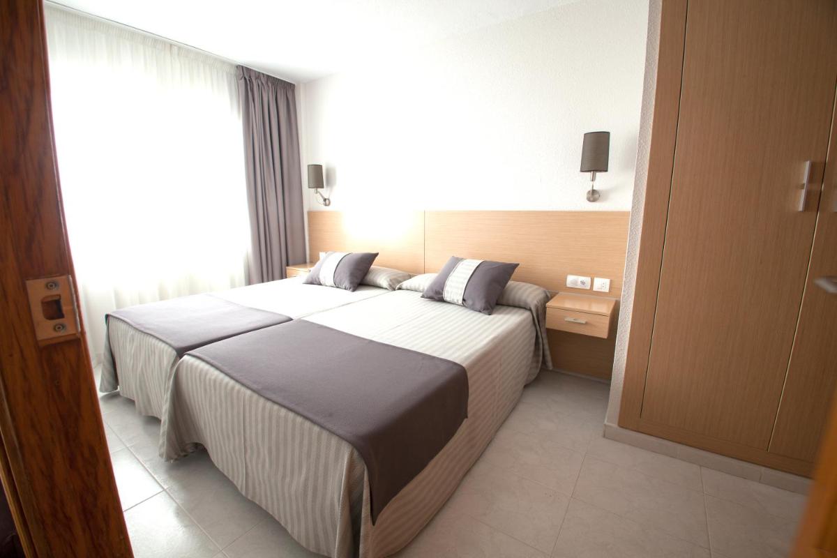 Cama o camas de una habitación en Aparthotel Acuazul