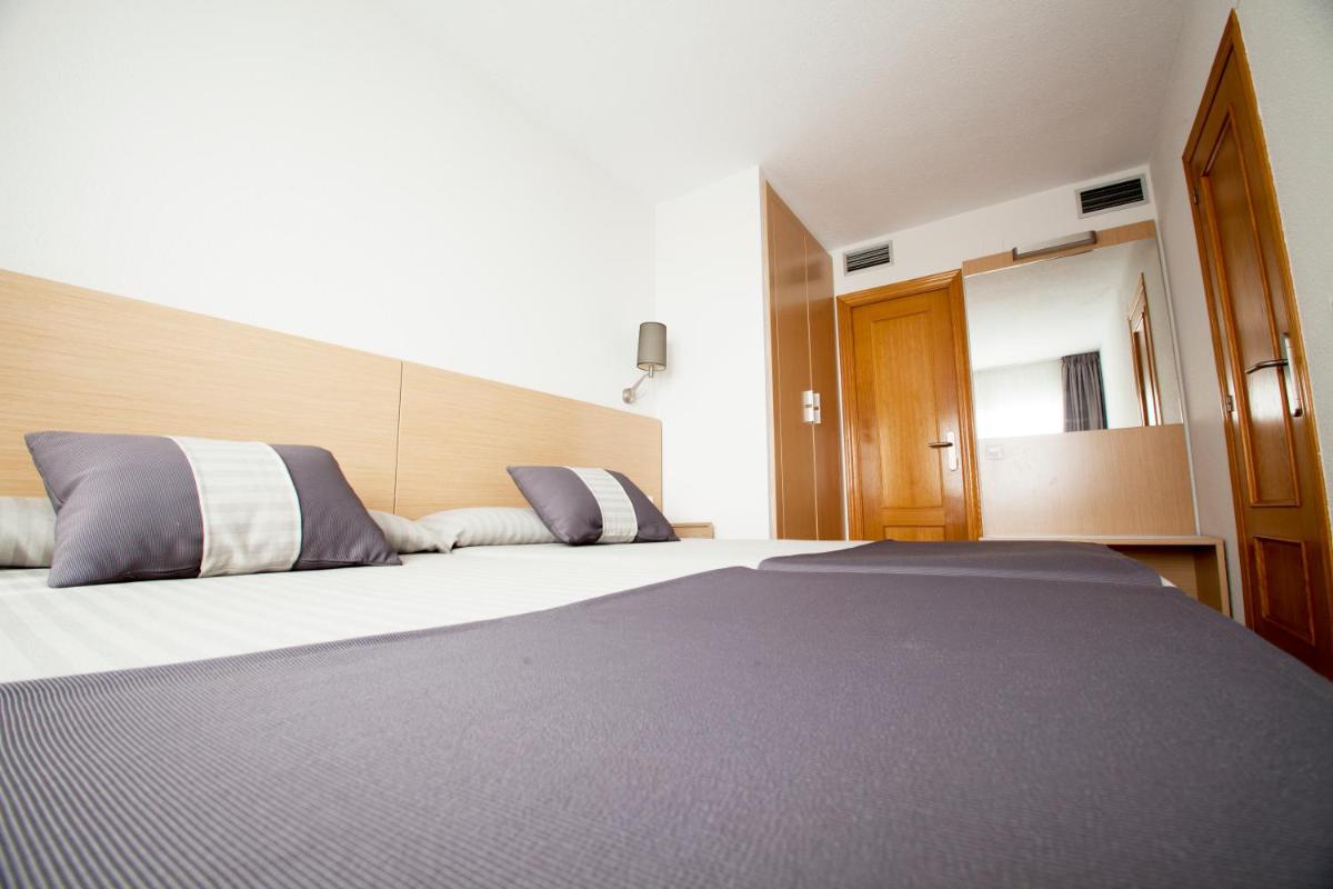 Cama o camas de una habitación en Aparthotel Acuazul