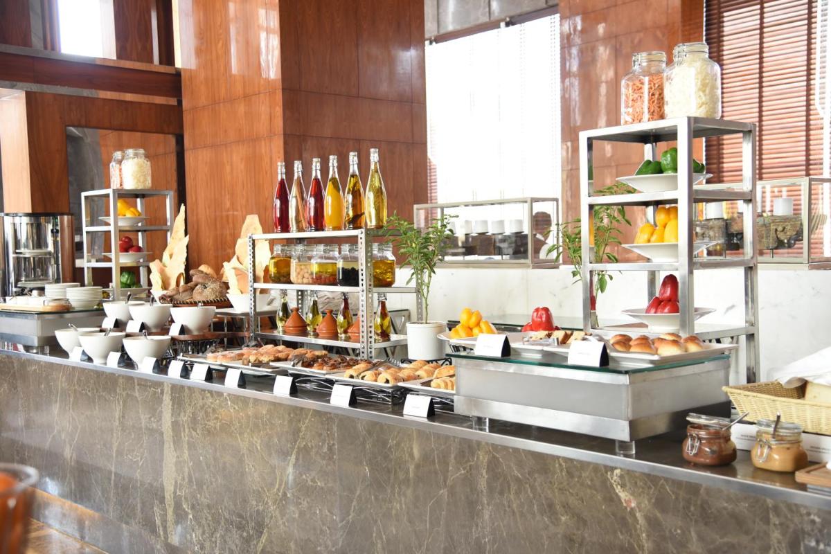 a buffet line with a lot of food on display at Taj City Centre Gurugram in Gurgaon