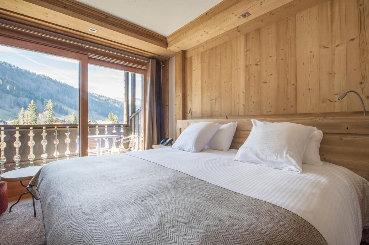 Un ou plusieurs lits dans un hébergement de l'établissement Hotel le Petit Dru