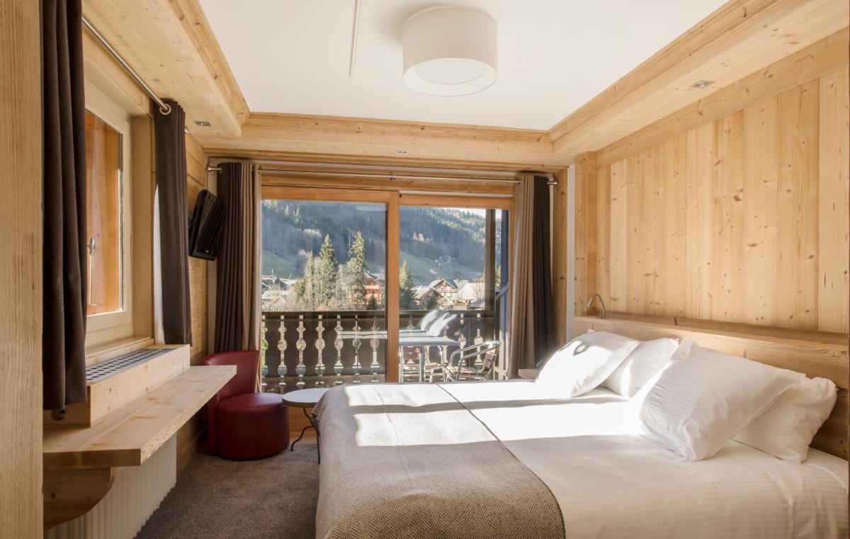 Un ou plusieurs lits dans un hébergement de l'établissement Hotel le Petit Dru