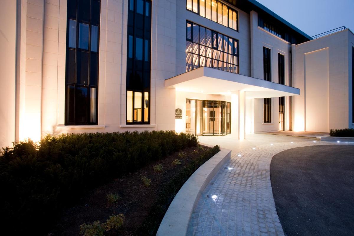 un grand bâtiment avec un chemin devant dans l'établissement Best Western Plus Hotel des Francs, à Soissons