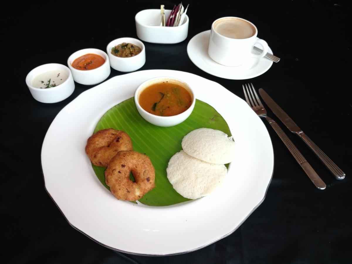 a plate of food on a table with a plate of food at Vivanta Hyderabad, Begumpet in Hyderabad a plate of food on a table with a plate of food at Vivanta Hyderabad, Begumpet in Hyderabad