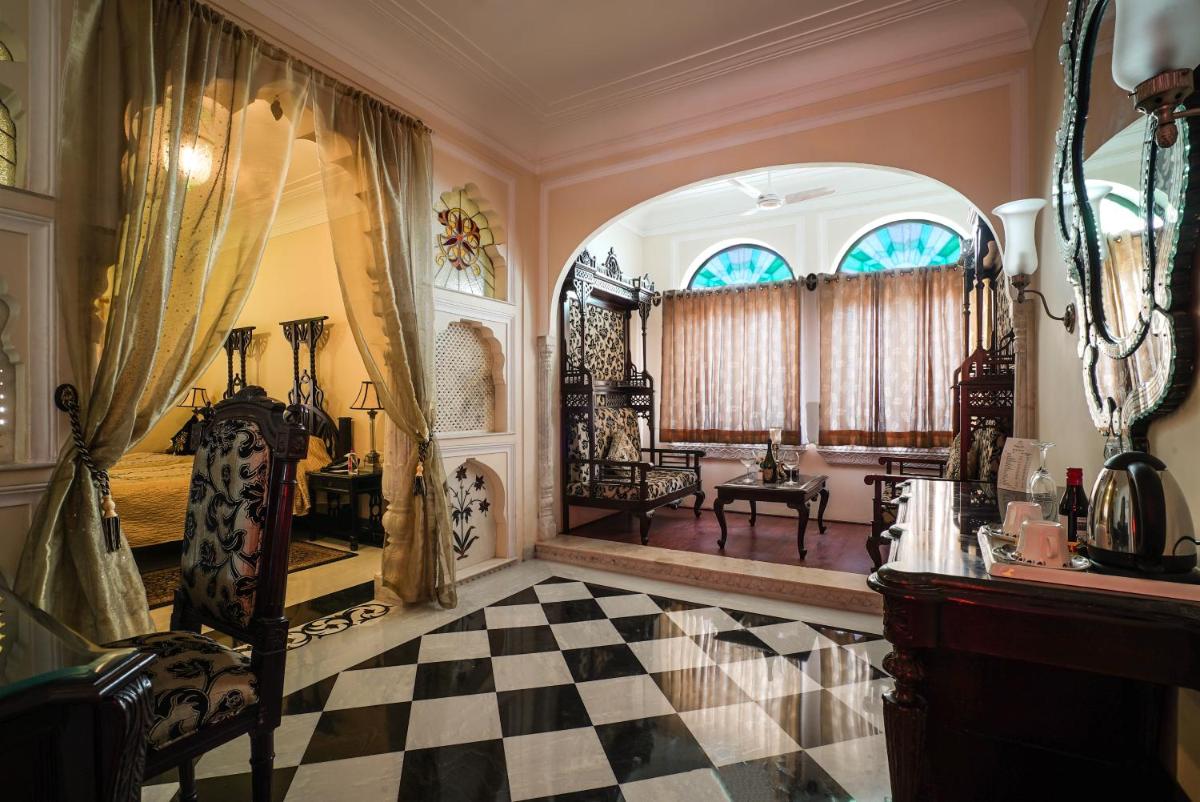 a living room with a checkered floor and an entry way at Shahpura House in Jaipur