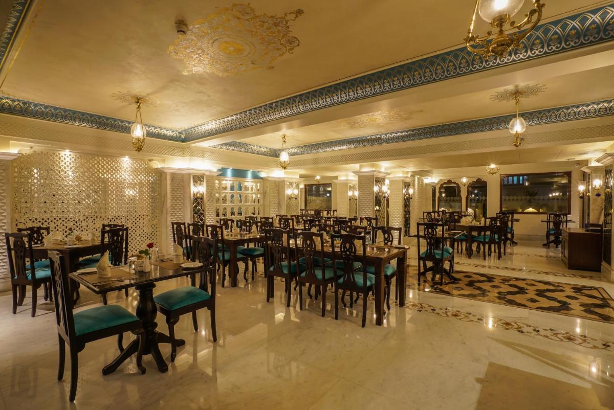 a restaurant with tables and chairs in a room at Shahpura House in Jaipur