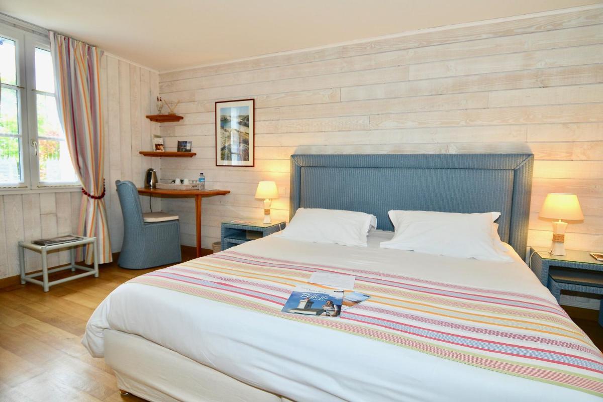 Un ou plusieurs lits dans un hébergement de l'établissement La Désirade - Hôtel, Spa & Restaurant