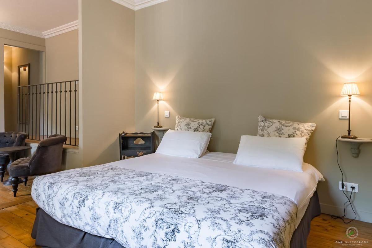 Un ou plusieurs lits dans un hébergement de l'établissement Hôtel Restaurant Spa Le Sauvage