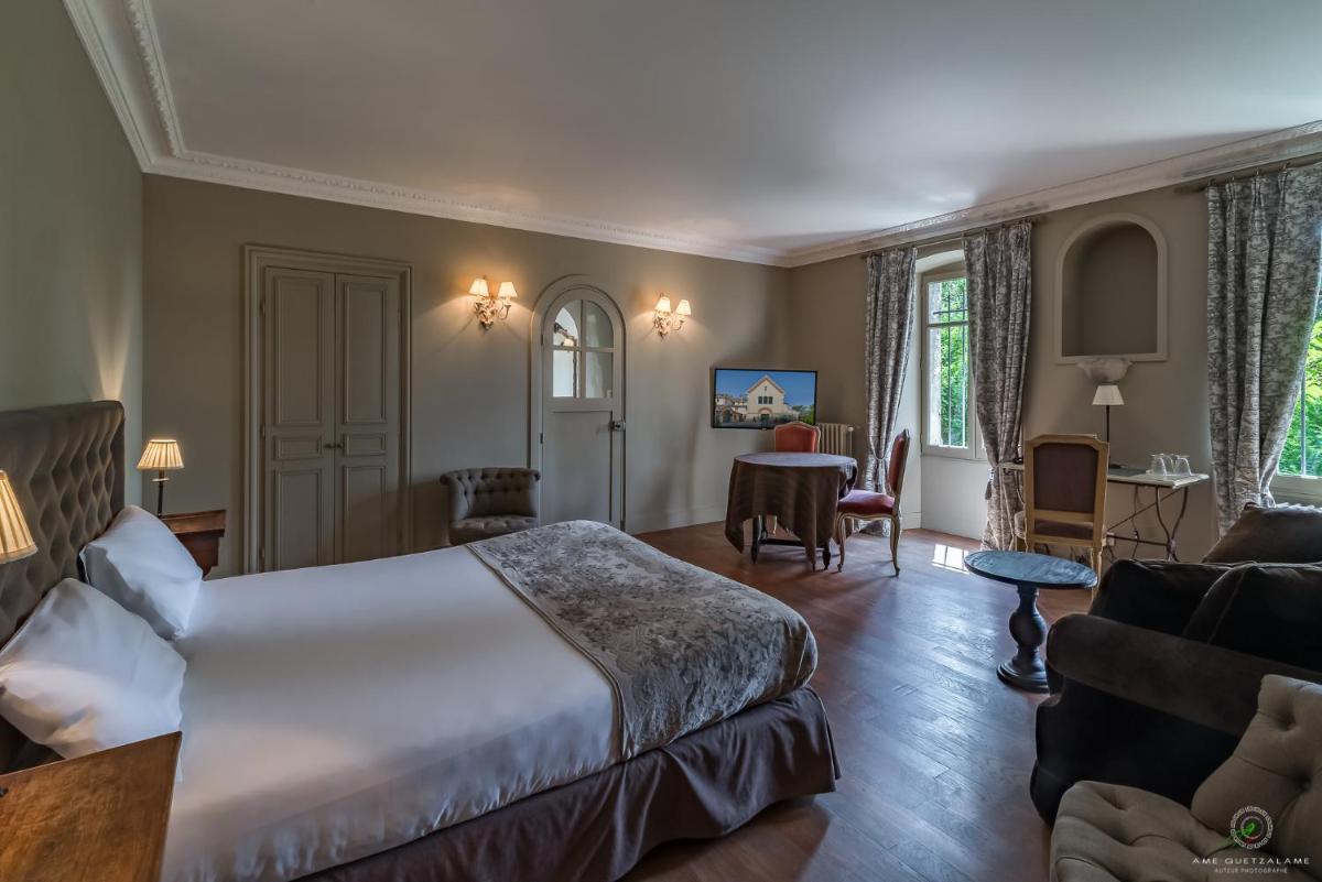 Un ou plusieurs lits dans un hébergement de l'établissement Hôtel Restaurant Spa Le Sauvage
