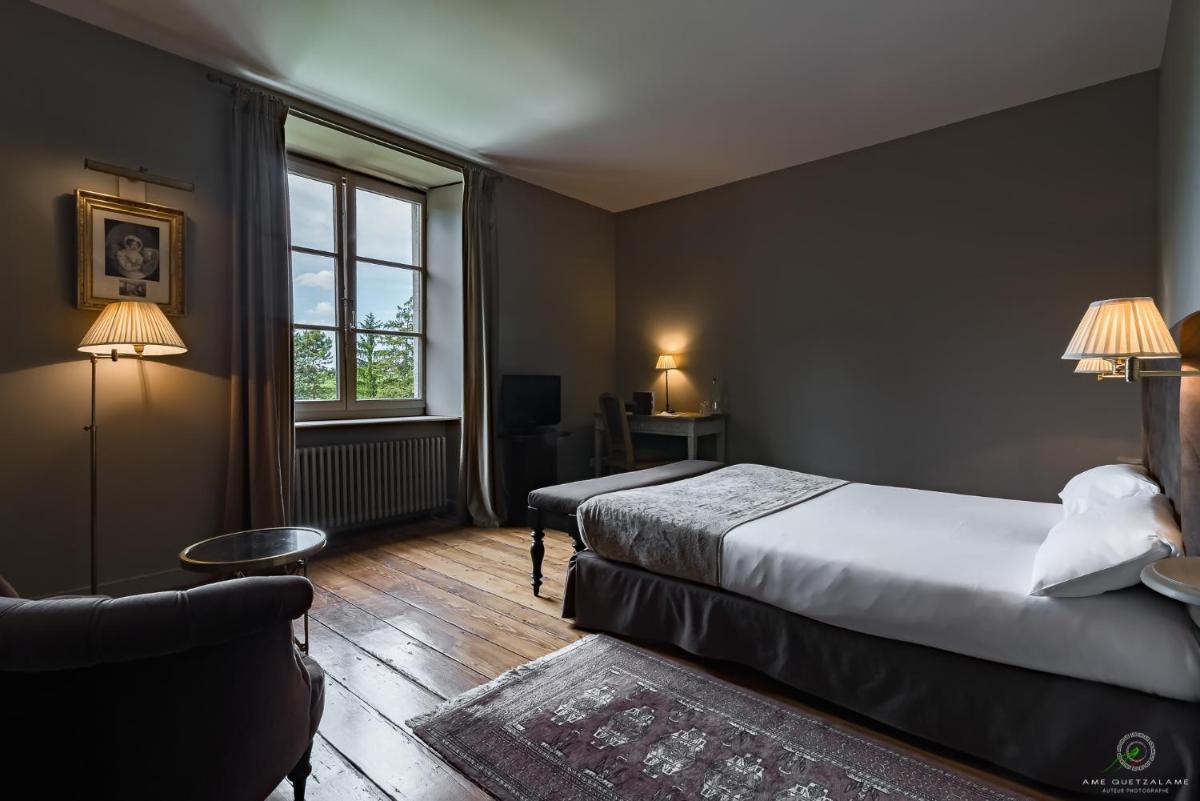Un ou plusieurs lits dans un hébergement de l'établissement Hôtel Restaurant Spa Le Sauvage