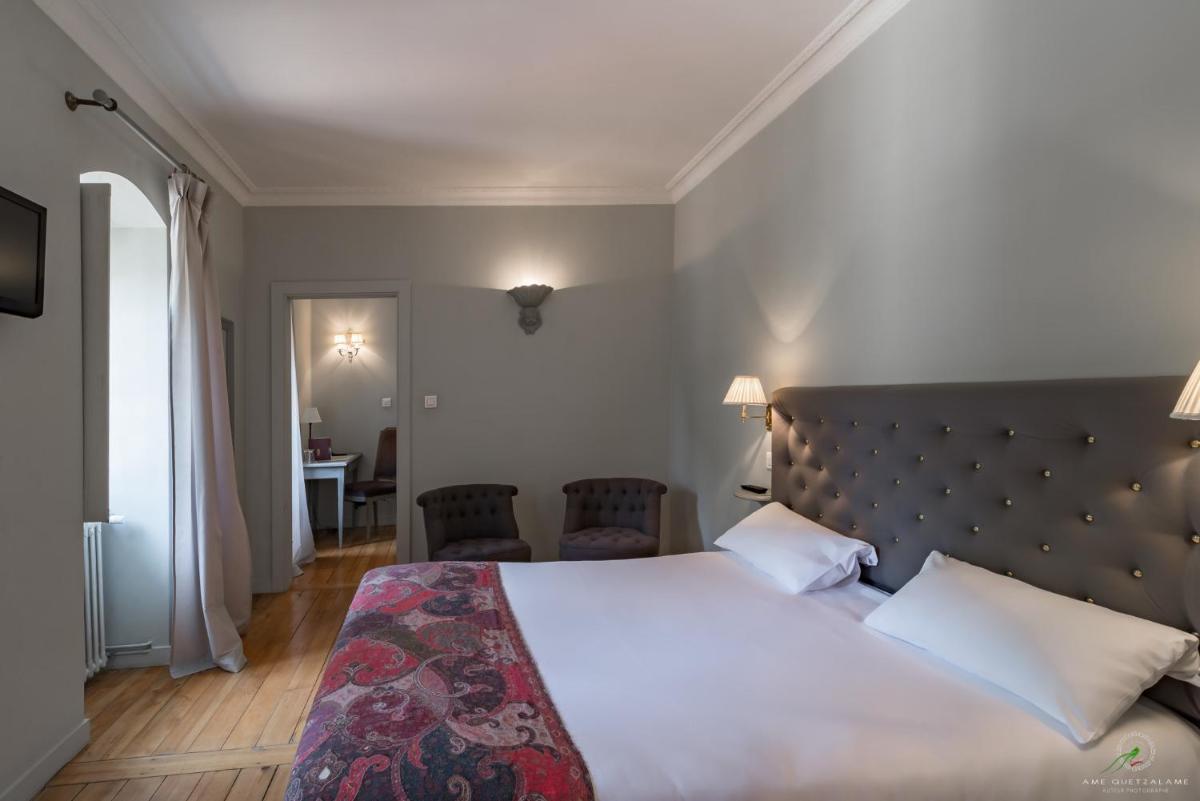 Un ou plusieurs lits dans un hébergement de l'établissement Hôtel Restaurant Spa Le Sauvage