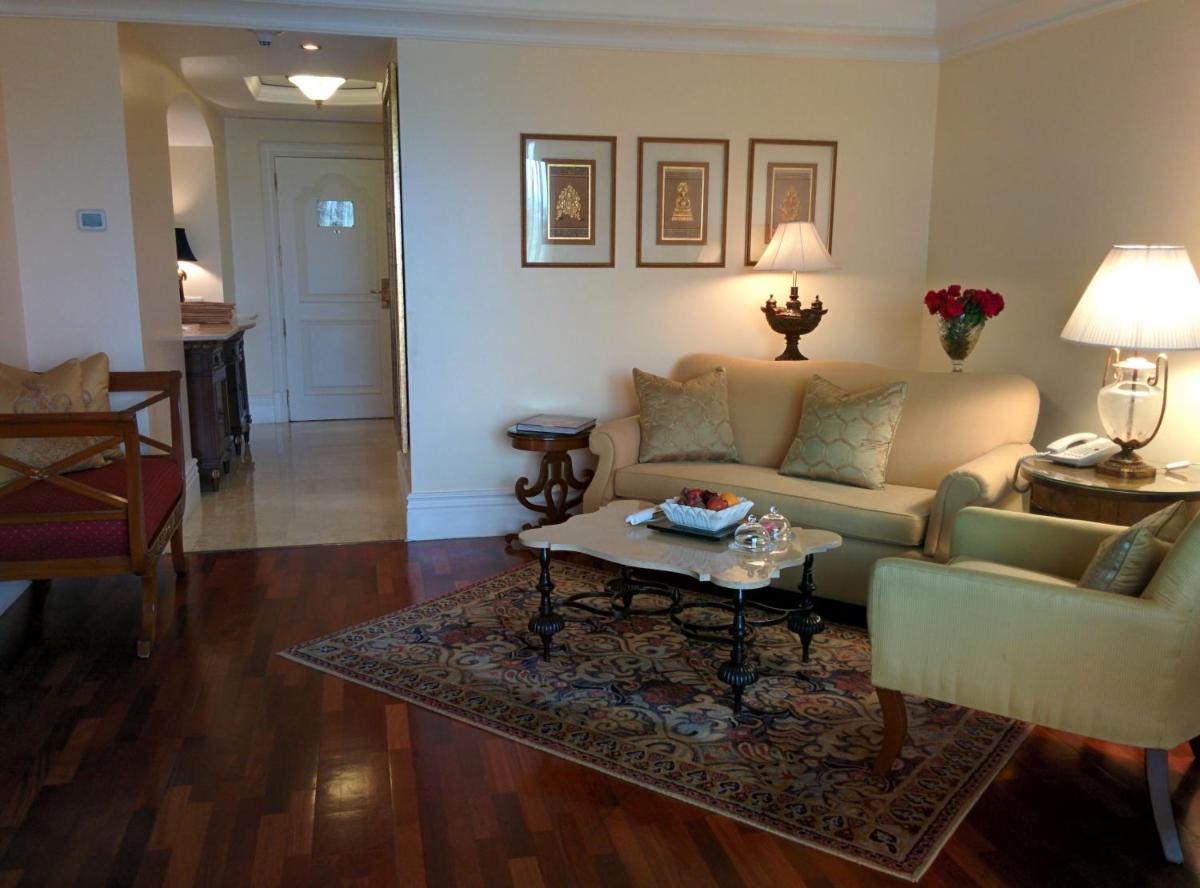 a living room with a couch and a coffee table at The Leela Palace Bengaluru in Bengaluru a living room with a couch and a coffee table at The Leela Palace Bengaluru in Bengaluru