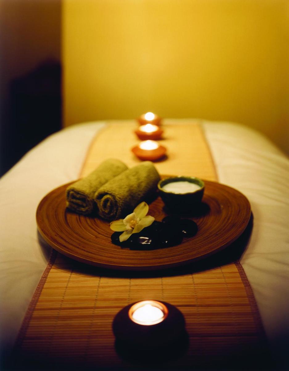 a tray of food on a bed with two candles at Hyatt Regency Lucknow Gomti Nagar in Lucknow