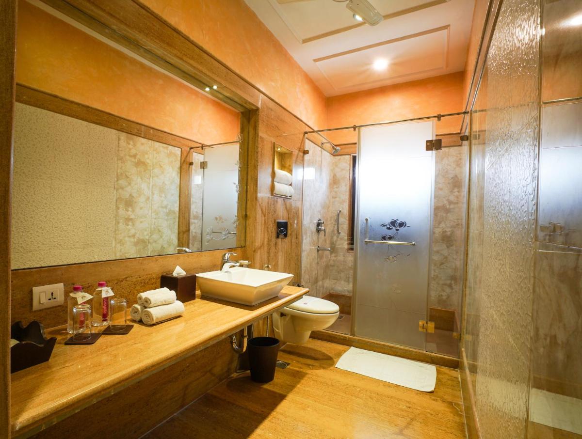 a bathroom with a sink and a toilet and a shower at Shahpura House in Jaipur