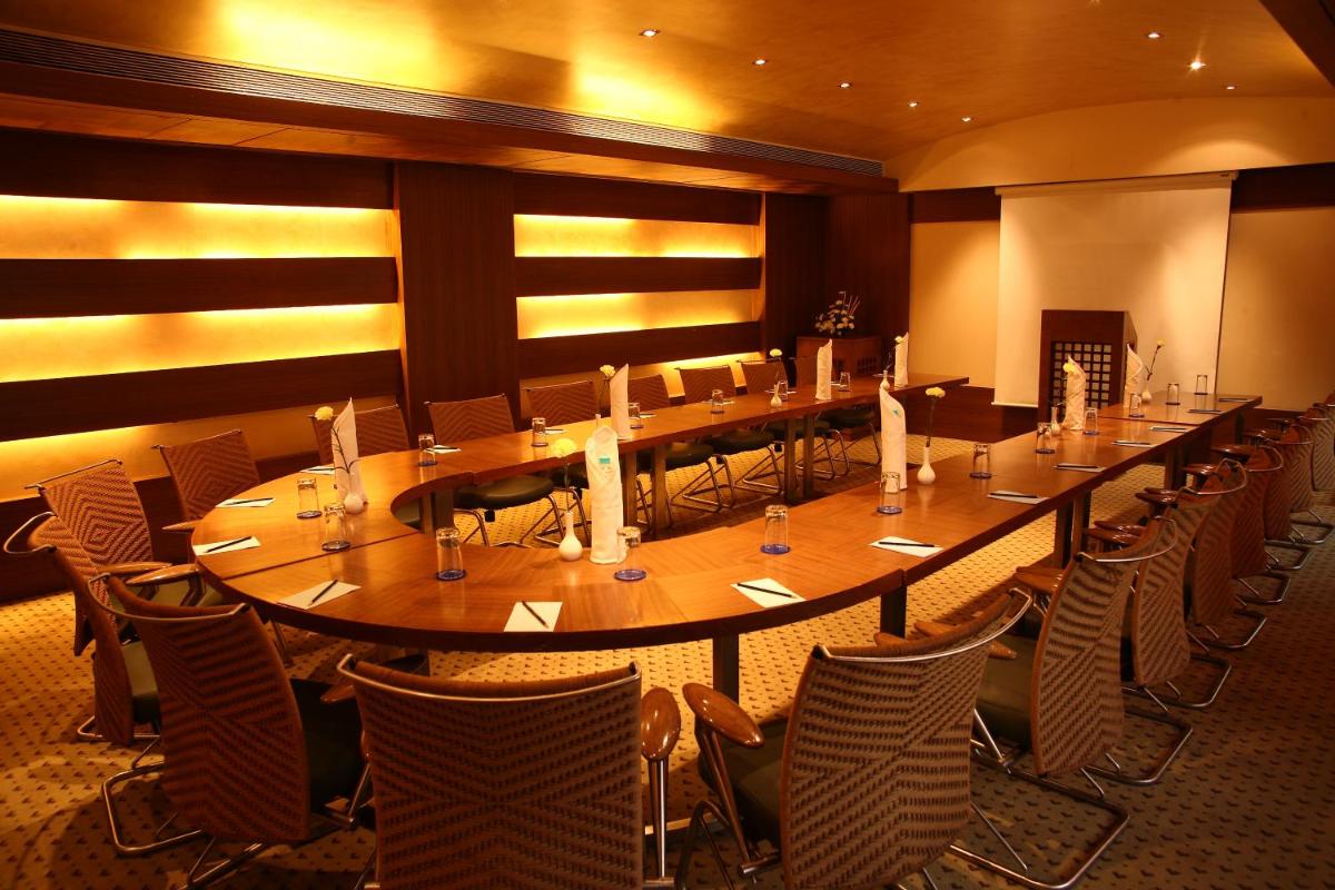 a large long table in a room with chairs at Sun-n-Sand Mumbai Juhu Beach in Mumbai