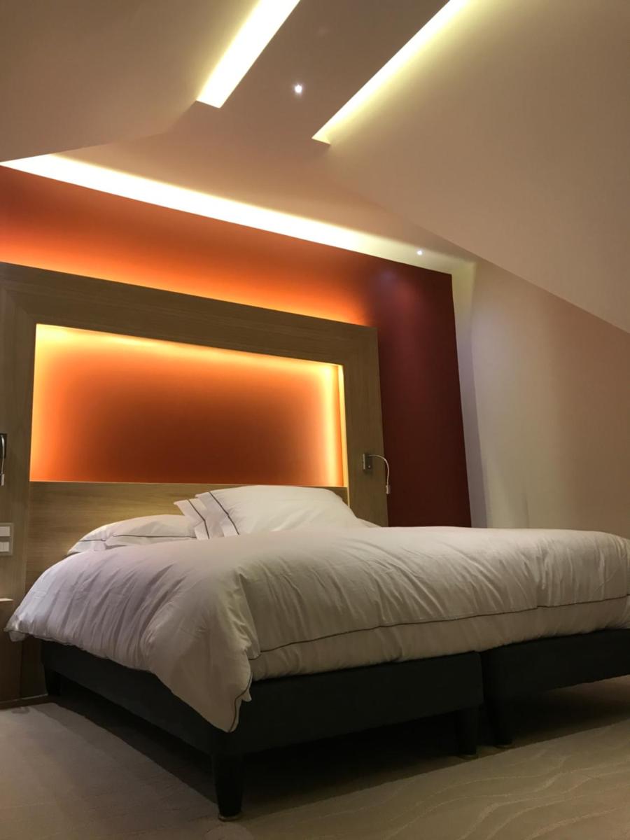 Un ou plusieurs lits dans un hébergement de l'établissement Au Soleil, Hôtel Restaurant & Spa
