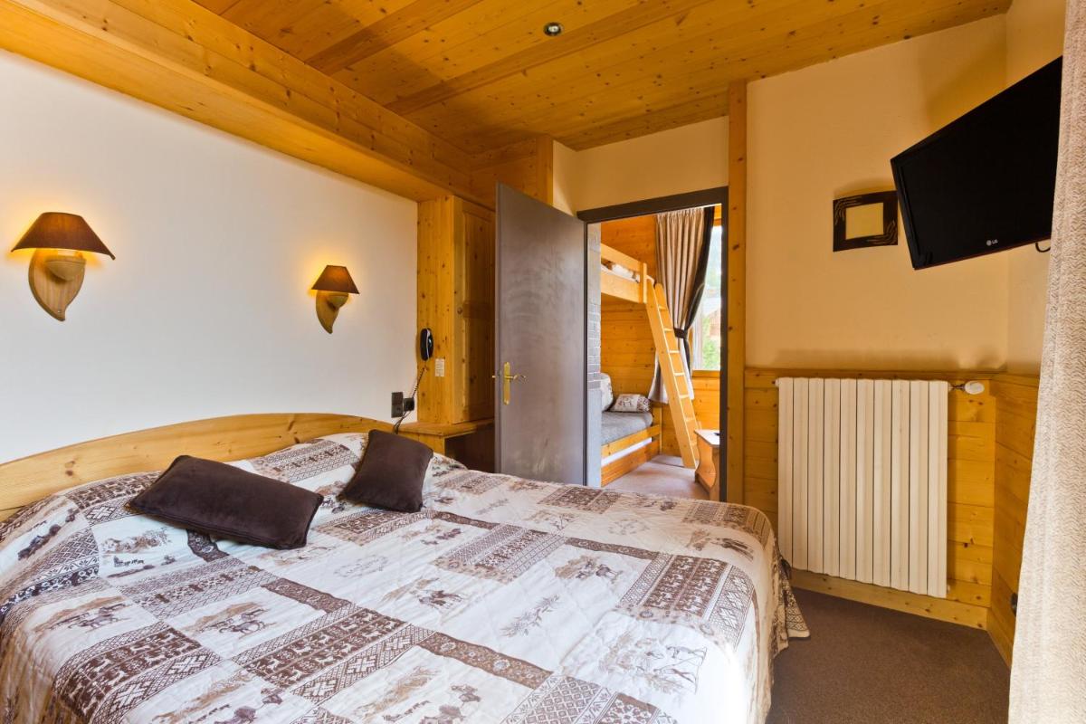 Un ou plusieurs lits dans un hébergement de l'établissement Logis Hotel & Spa Beau-Site