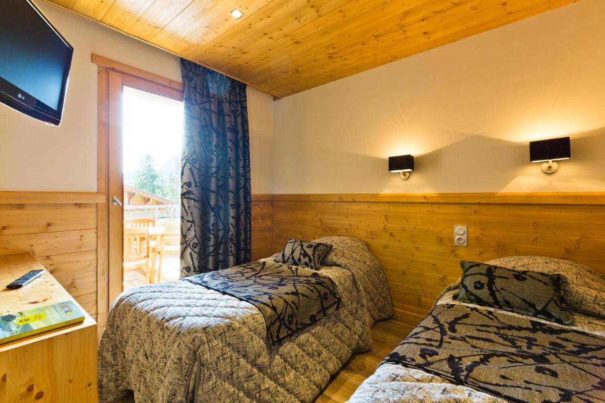 Un ou plusieurs lits dans un hébergement de l'établissement Logis Hotel & Spa Beau-Site