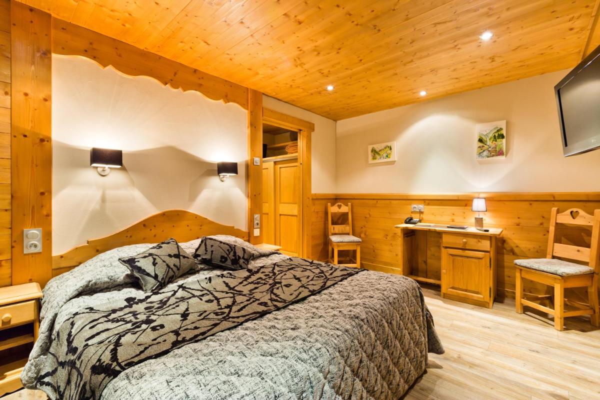 Un ou plusieurs lits dans un hébergement de l'établissement Logis Hotel & Spa Beau-Site