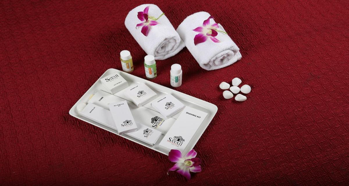 a group of pills and towels next to a keyboard at Sayaji Pune in Pune