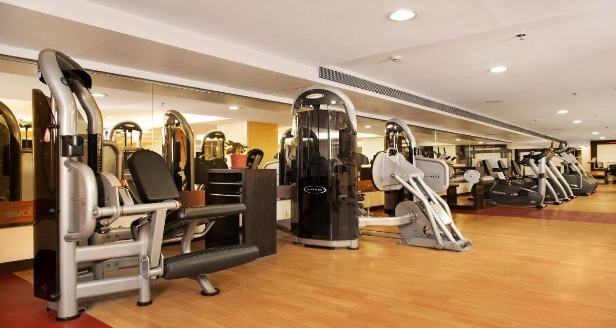 a gym with a bunch of treadmills in it at Sayaji Pune in Pune