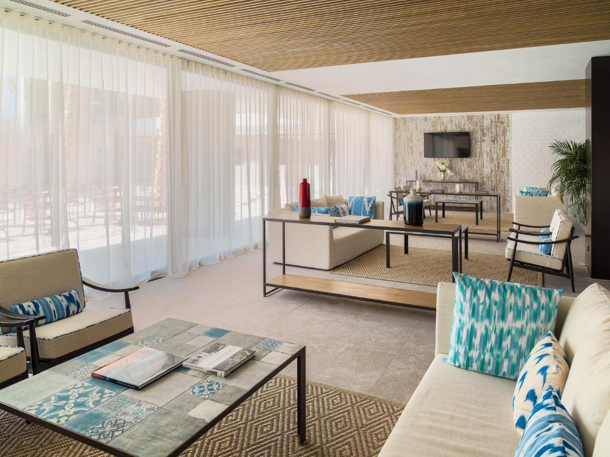 una sala de estar con un sofá y una mesa en H10 Casa del Mar, en Santa Ponsa