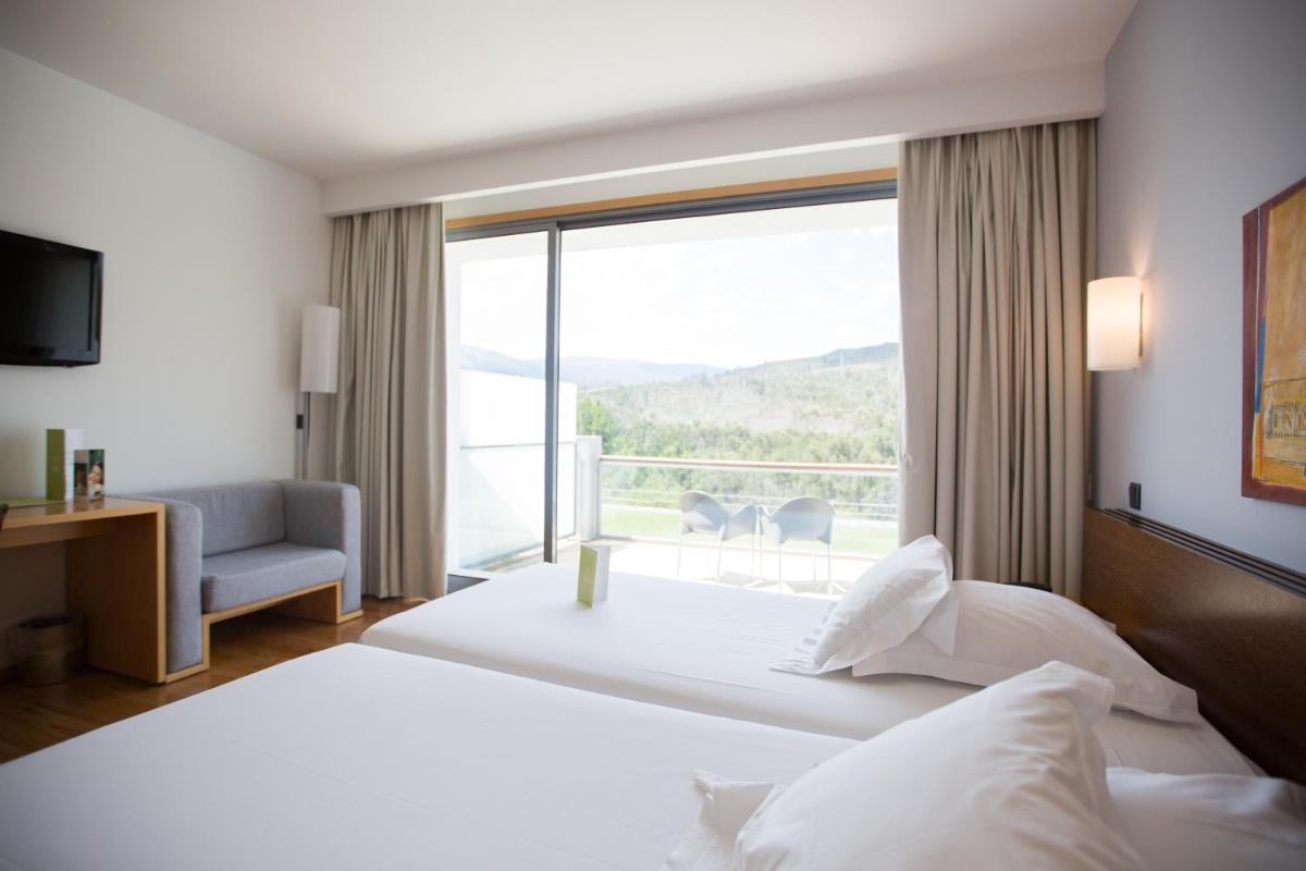 Uma cama ou camas num quarto em Monte Prado Hotel & Spa