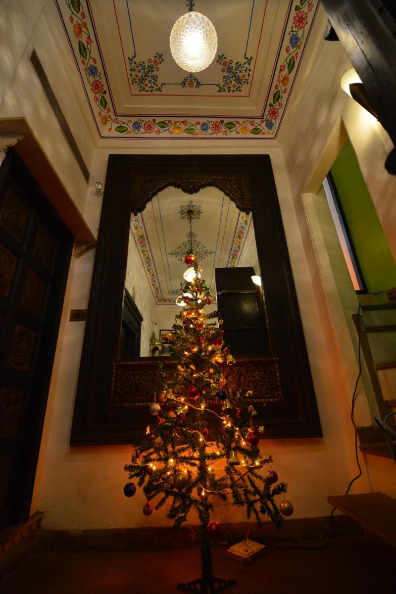 a christmas tree in a room with a wall at Haveli Dharampura & Golden Haveli- UNESCO awarded Boutique Heritage Hotel in New Delhi a christmas tree in a room with a wall at Haveli Dharampura & Golden Haveli- UNESCO awarded Boutique Heritage Hotel in New Delhi