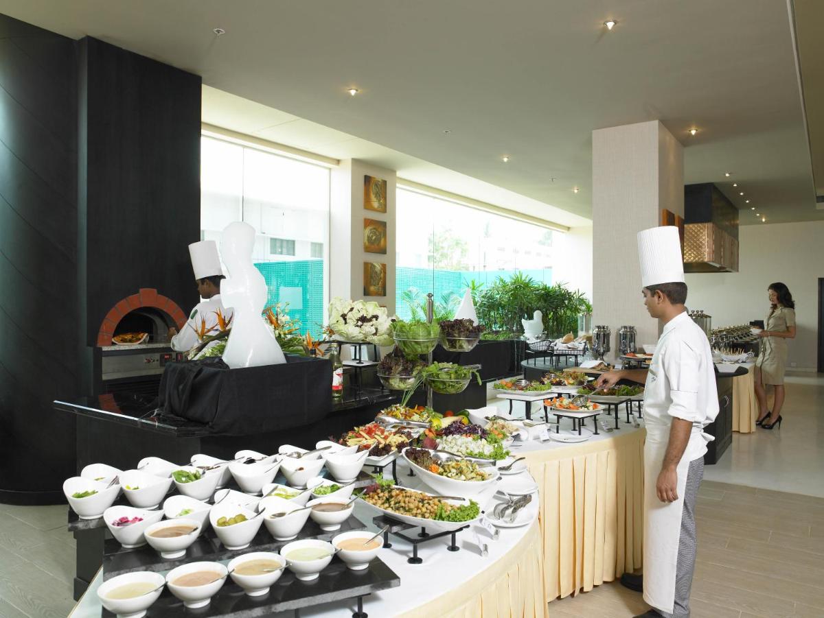 a buffet of food with chefs standing in front of it at The Zuri Whitefield Bengaluru in Bengaluru a buffet of food with chefs standing in front of it at The Zuri Whitefield Bengaluru in Bengaluru